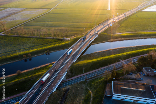 A viaduct bridge crossover a canal of highway A59 during sunrise near Waalwijk, Noord Brabant, Netherlands