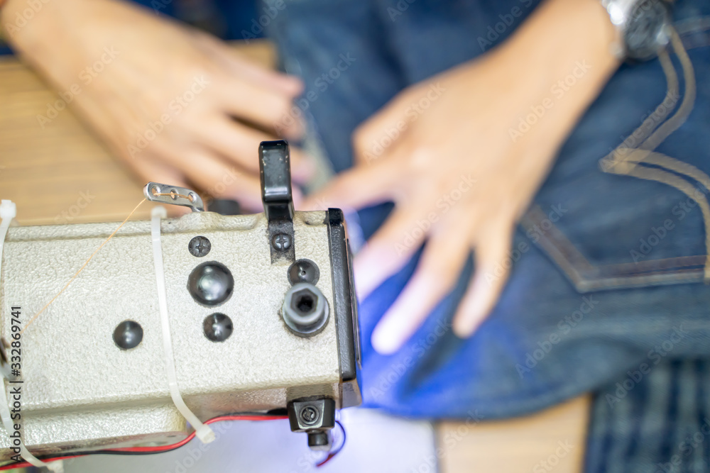 hands working on the sewing machine hands working on the sewing machine