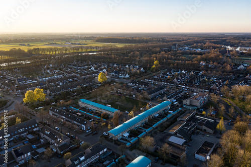 A residential area seen from above during a sunny sunrise in Waalwijk, Noord Brabant, Netherlands