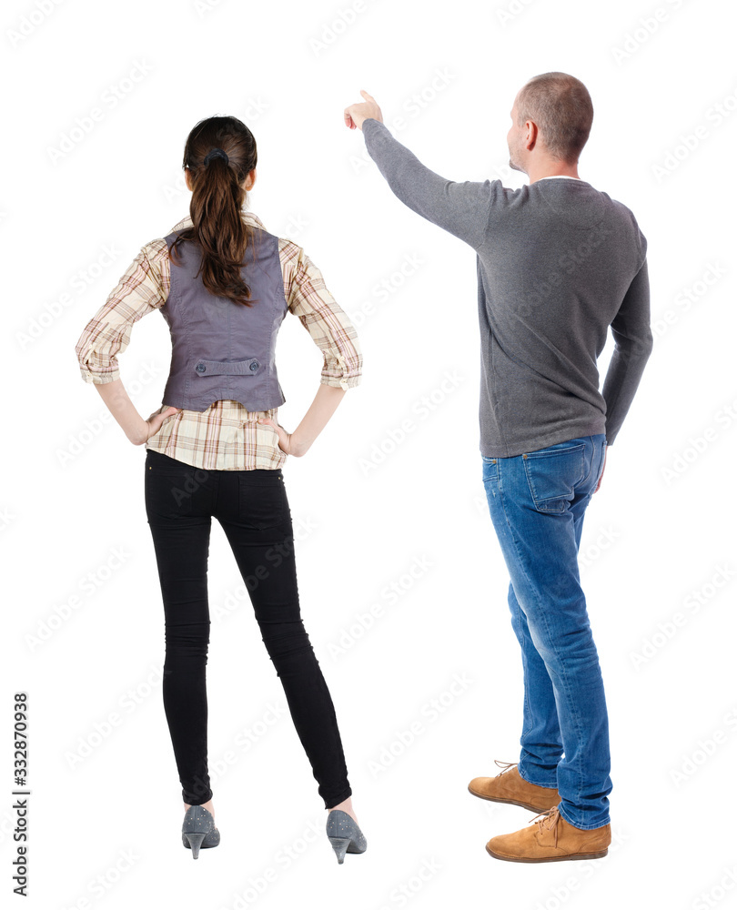 Back view of couple in sweater pointing. Back view of couple in sweater pointing.