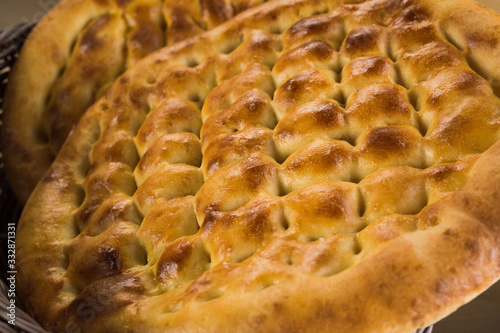 Turkish ramazan pidesi - Traditional Turkish ramadan flatbreads which bake during ramadan month. Blue stone background. Top view photo