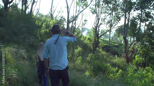 A group of archaeologists with a guide travel through the jungle of Sri Lanka, looking for treasures, exploration photo