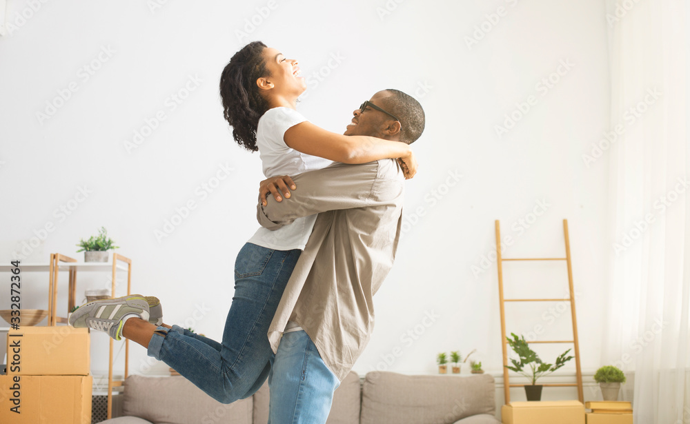 African american millennial couple hugging and whirling