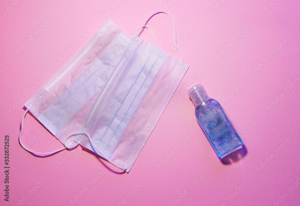 Antiseptic and masks on a pink baackground Antiseptic and masks on a pink baackground