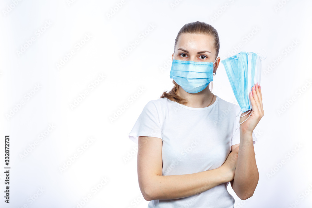 A girl in a protective medical mask holds in her hands means to protect the respiratory tract from the virus. A girl in a protective medical mask holds in her hands means to protect the respiratory tract from the virus.