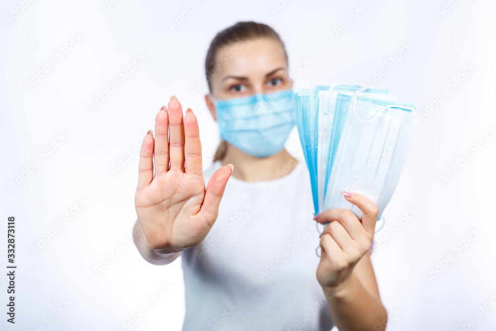 A girl in a protective medical mask holds in her hands means to protect the respiratory tract from the virus. A girl in a protective medical mask holds in her hands means to protect the respiratory tract from the virus.