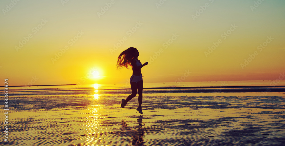  girl running by the sea on the beach