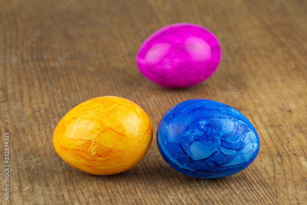 colorful easter eggs on a wooden board colorful easter eggs on a wooden board