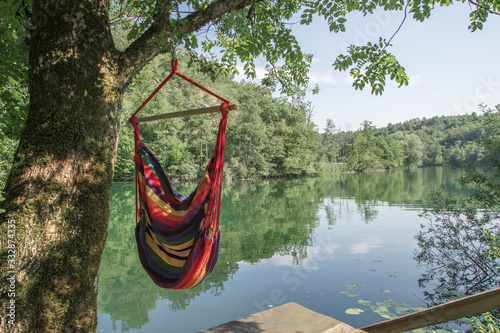 Chilling By The Beautiful River In Hanging Chair Tied To A Tree