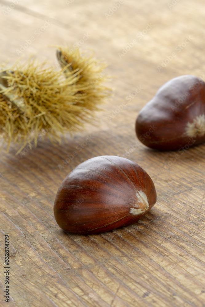 sweet chestnut fruits on a wooden cutting board