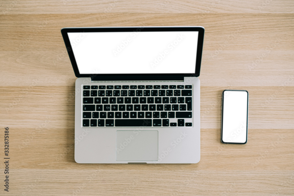 Man's hands using laptop with blank screen on desk in home interior. Mockup image white screen. Man's hands using laptop with blank screen on desk in home interior. Mockup image white screen.