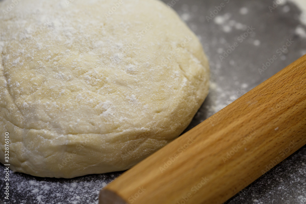 flour dough for baking cookies on the kitchen table flour dough for baking cookies on the kitchen table