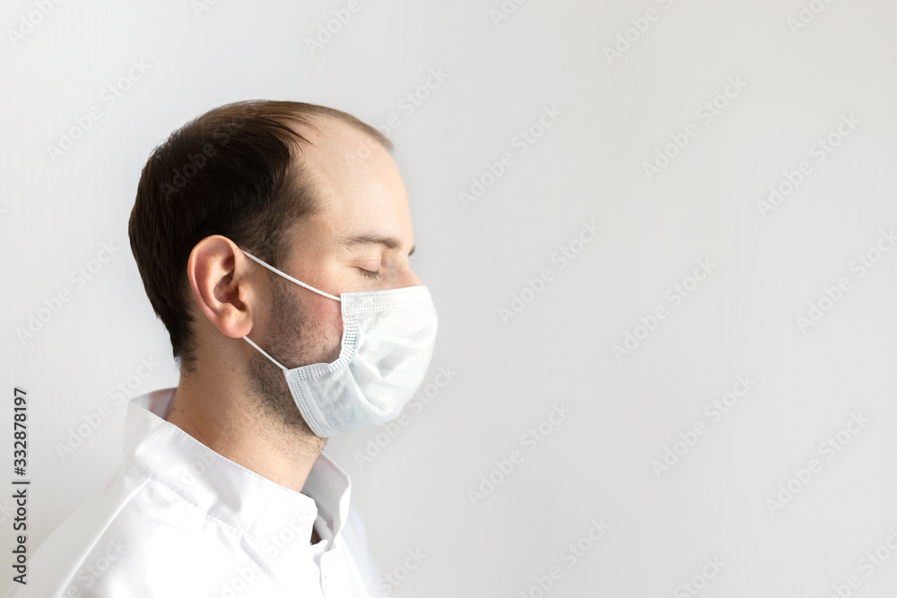 Virus mask male doctor wearing face protection in prevention for coronavirus closed eyes copyspace