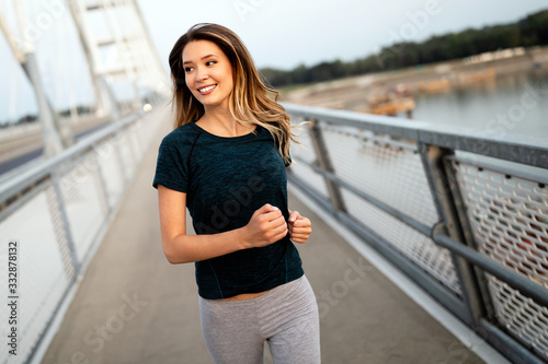 Sporty woman jogging in city to keep her body and soul in shape © NDABCREATIVITY
