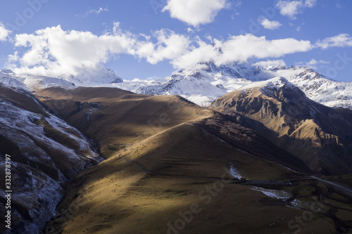 Kazbegi Mountain in Georgia - with some clouds on it and snow.
