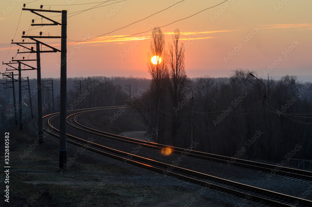 Spring dawn, red sun and the outgoing railway.
