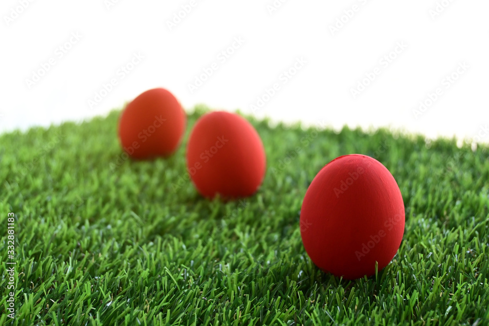 red easter egg on lawn green grass artificial with blank white background red easter egg on lawn green grass artificial with blank white background