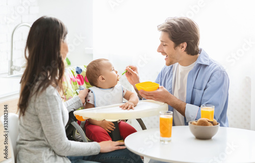 Millennial family having breakfast together at kitchen