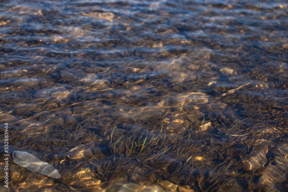 Close-up of river water with pebbles and bubbles Close-up of river water with pebbles and bubbles