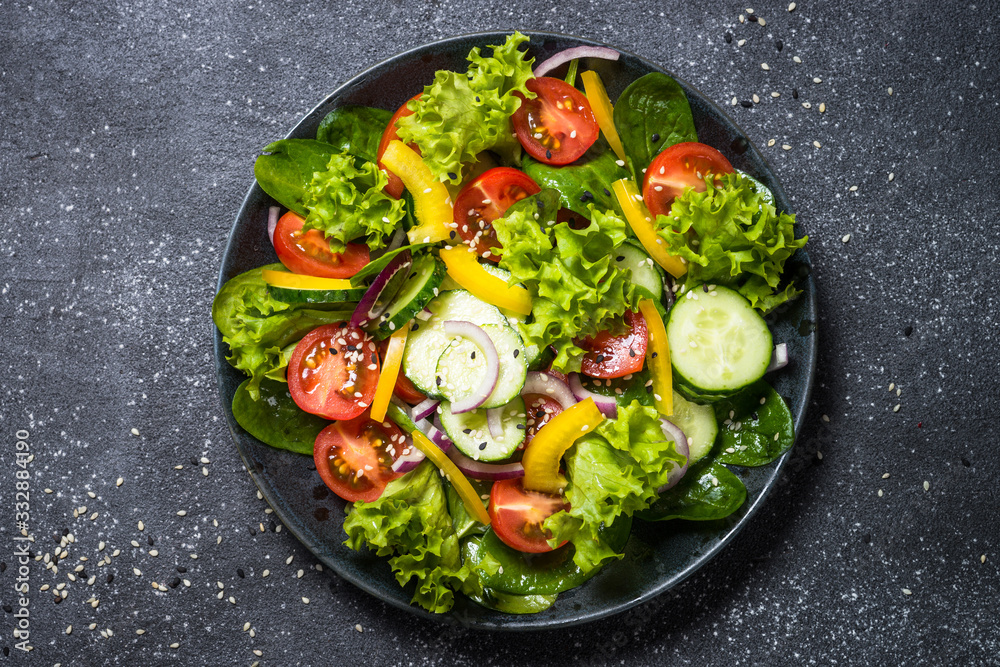 Fresh vegetables salad on black. Fresh vegetables salad on black.