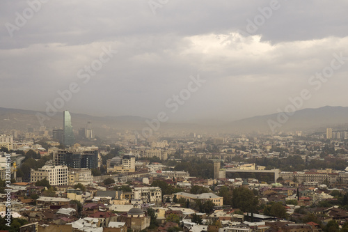 Sun trying pass through smog above the Tbilisi - capital of Georgia