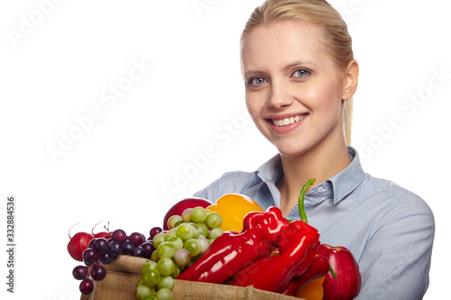 Woman holding grocery paper shopping bag full of fresh vegetables. Diet healthy eating concept isolated on a white background