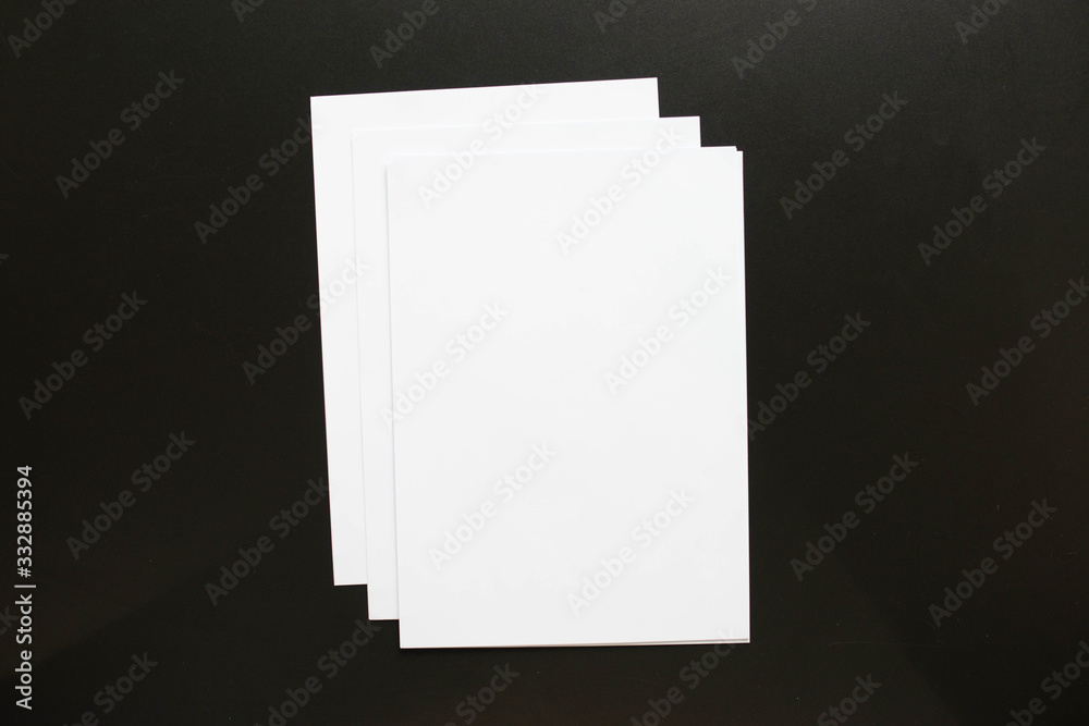 Blank Paper Stack Lying on Black Desk Blank Paper Stack Lying on Black Desk