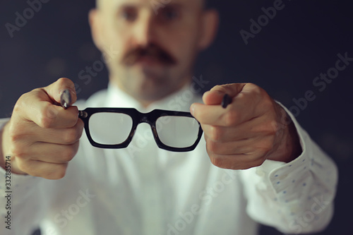 doctor offers glasses, medicine concept, eyesight, man holds out glasses