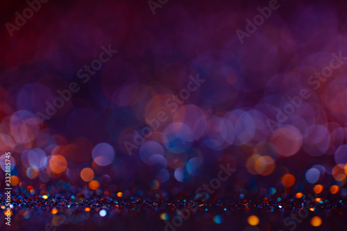 Decoration twinkle lights background, abstract blurred backdrop with circles,modern design wallpaper with sparkling glimmers. Purple, blue and golden backdrop glittering sparks with glow effect photo