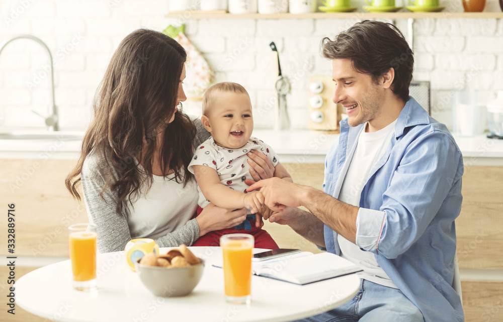 Young family enjoying morning together at kitchen Young family enjoying morning together at kitchen