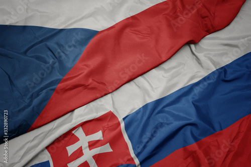 waving colorful flag of slovakia and national flag of czech republic.