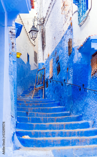 Easel with a picture on the street in Chefchaouen, Morocco. Vertical. © ggfoto