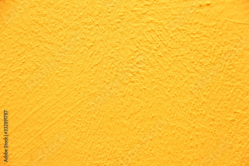 Yellow wall texture. Bright warm yellow wall background
