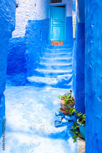 Narrow street in the blue city, Chefchaouen, Morocco. Vertical. © ggfoto