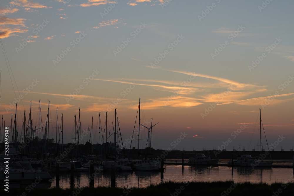 evening falls over the marina with still light spots in the air