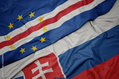 Canvas Print waving colorful flag of slovakia and national flag of cape verde.