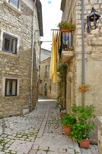 Fototapeta Naklejka Na Ścianę i Meble -  A narrow street between the old houses of the medieval village of Oratino, in Italy.