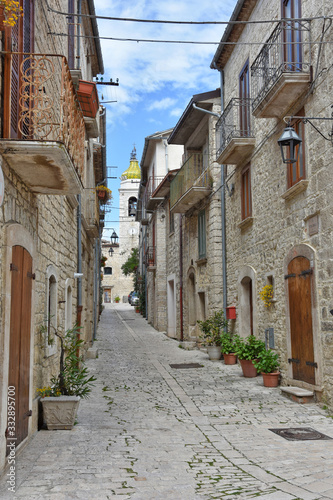 A narrow street between the old houses of the medieval village of Oratino  in Italy.