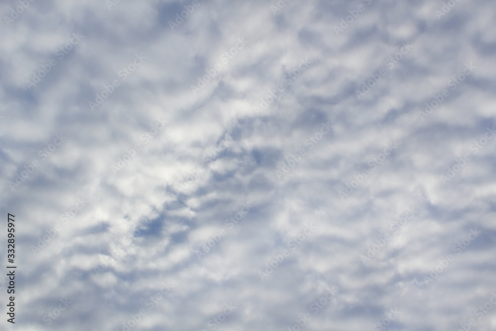 Grey abstract clouds lines on blue sky background