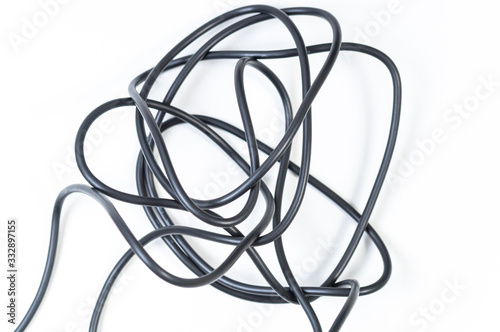 tangled black wire on a white background, selective focus