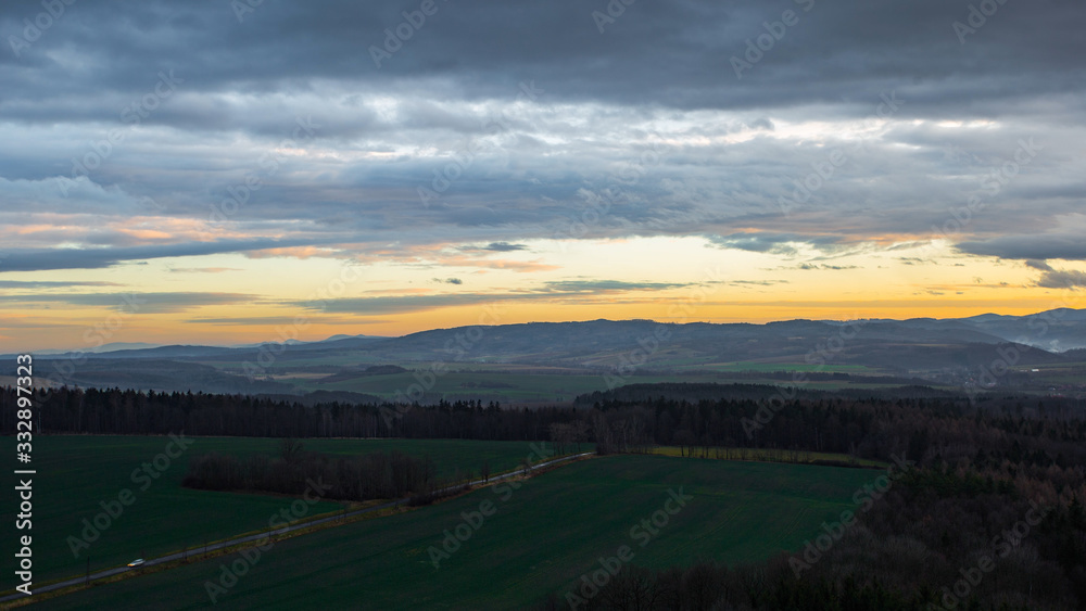 The beautiful countryside of Poland with a road going through green grass plains The beautiful countryside of Poland with a road going through green grass plains