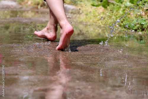 Boy runs on water splashing legs