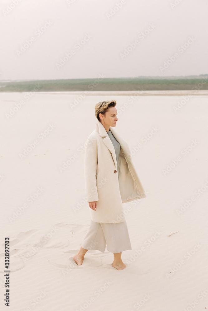 Portrait of mature middle age woman in casual trendy clothes walking in countryside beach. Concept Of Enjoying Life At Any Age. Natural Ageing Portrait of mature middle age woman in casual trendy clothes walking in countryside beach. Concept Of Enjoying Life At Any Age. Natural Ageing
