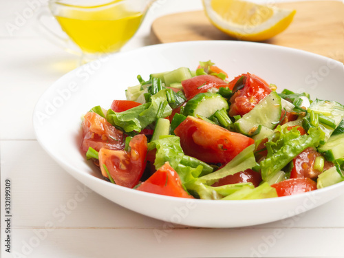Salad of tomatoes, cucumbers and herbs. Healthy food, vegan, vegetarian.