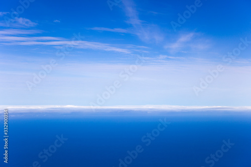 Blue sea and sky horizon with clouds