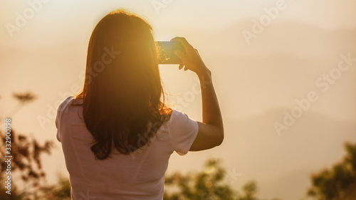 Woman taking photo with smartphone