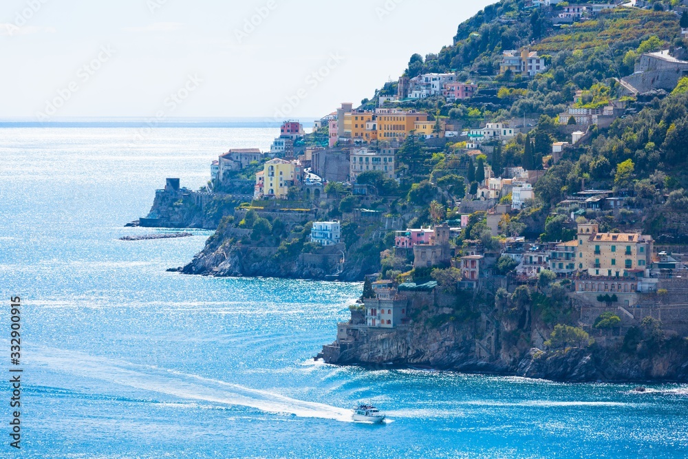 Amalfi coast with coloured terrace houses on hills leading down to sea located between Amalfi and Atrani in Campania, Italy.