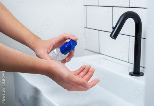 Applying disinfectant hand gel to protect against bacteria and viruses photo