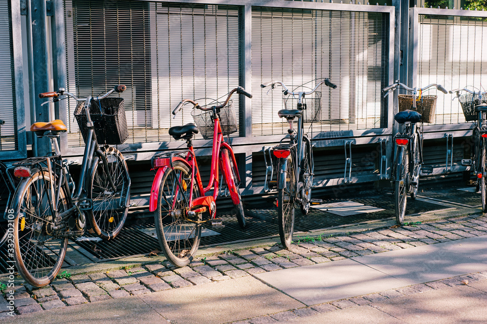 Many vintage bicycles parking at the street.