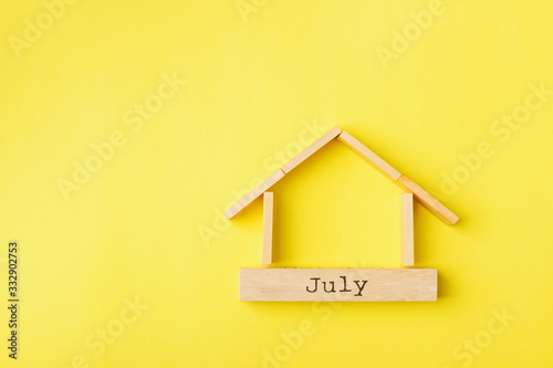 house shaped wooden logs on the yellow background